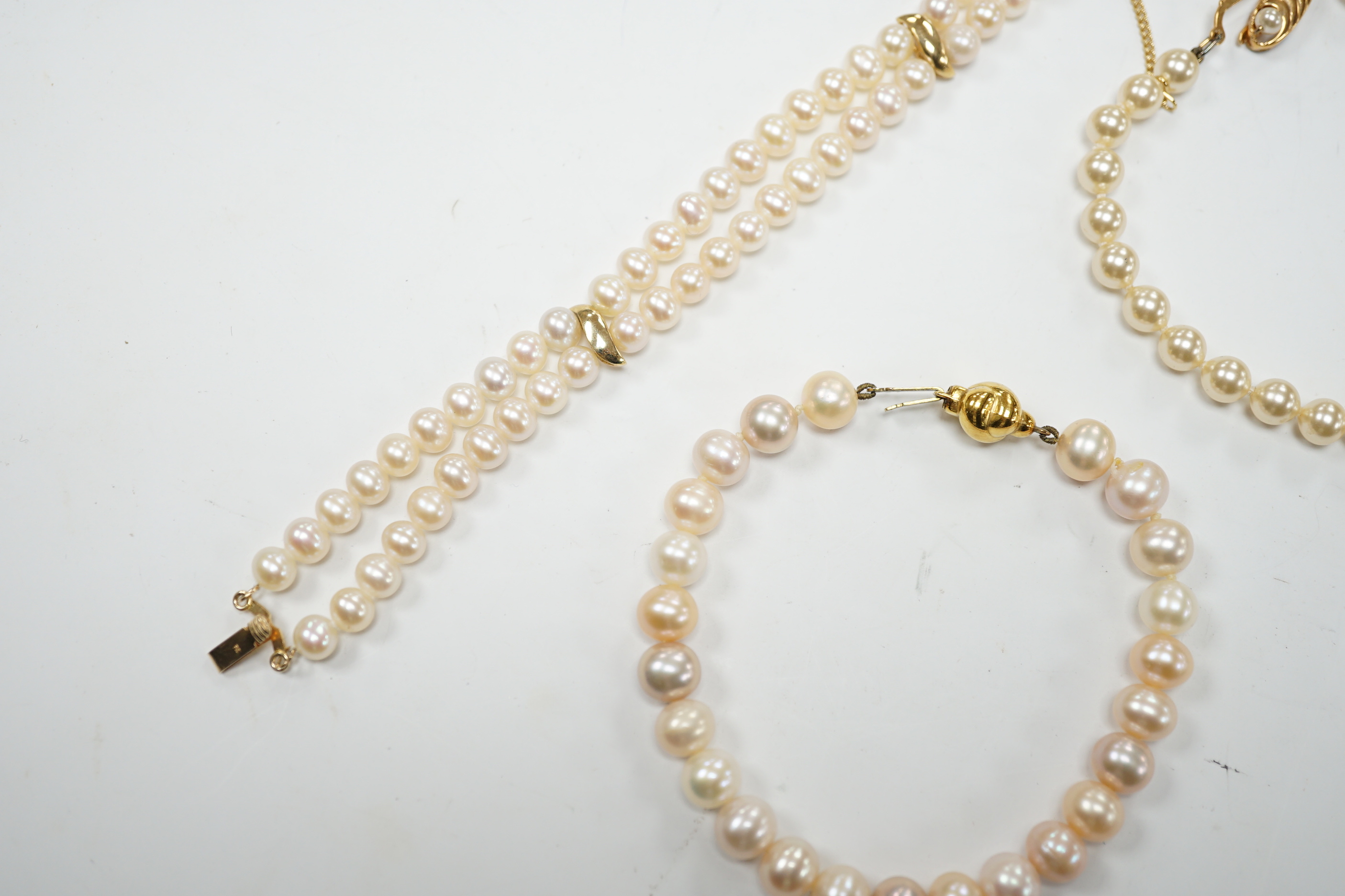 A modern double strand cultured pearl bracelet, with 14k clasp, 18cm, one other cultured pearl bracelet with 375 clasp and a simulated pearl bracelet.